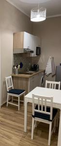 a kitchen with a table and two chairs and a table at Titti's Room in Casteldaccia