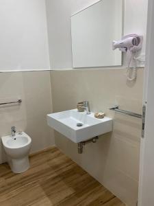 a bathroom with a sink and a toilet at Titti's Room in Casteldaccia