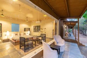 an open living room with a table and chairs at Tiger Machan in Sawāi Mādhopur
