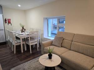 a living room with a couch and a table at Clifden Town Centre Apartment in Clifden