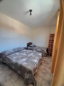 En eller flere senge i et værelse på Apartamento Confortável em Serra Negra