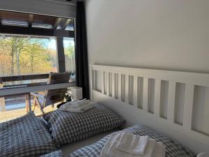 a bedroom with two beds and a large window at Ferienwohnung Leni in Siegsdorf