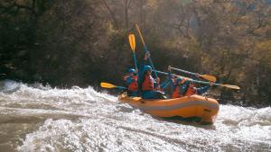 a group of people in a raft on a river at Sentio Camps - All Inclusive in Cabra Corral