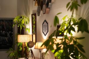 a room with a plant and a lamp and a mirror at 6 Elements Bedrooms With Event Space 4500 Sq Ft in Trivandrum