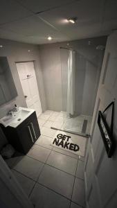 a bathroom with a get married sign on the floor at Cosy & Modern 2 Bedroom Apartment in Cardiff