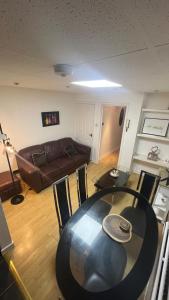 a living room with a table and a couch at Cosy & Modern 2 Bedroom Apartment in Cardiff