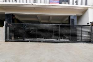 a black gate on the side of a building at Hotel O Infocity Square Road Bhubaneswar Formerly Avigna Premium in Bhubaneshwar