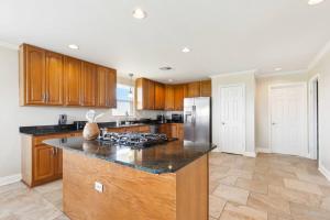 eine Küche mit Holzschränken und einem Herd mit Backofen in der Unterkunft Waterfront Getaway • Balcony + Bayou Views in Lafitte + 9 Fotos