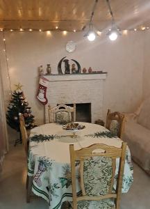 a dining room with a table and a christmas tree at olya's garden in Itʼkhvisi