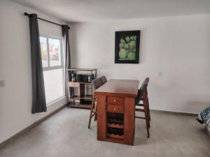 una sala da pranzo con tavolo e sedie in legno di Mini Hotel El Mezquite a Villa Doctor Mora