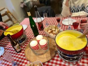 a table with a table with food and a bottle of wine at Histoire d Ardenne in La Roche-en-Ardenne +4 photos