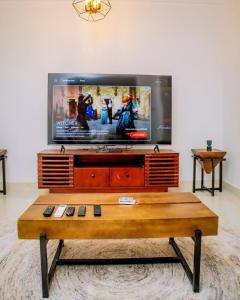 a flat screen tv sitting on top of a table at Manzi Hub Residence in Zanzibar City