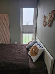 a bedroom with a bed and a window with butterflies on the wall at Kopje van Haaglanden in The Hague