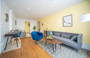a living room with a couch and a table at Place Carnot in Tournus +9 photos