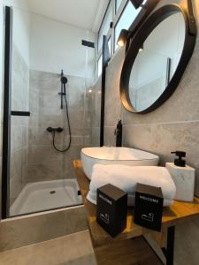 a bathroom with a tub and a sink and a mirror at Splendid T4 - Spacious - Air conditioning - 6 People in Pau +37 photos
