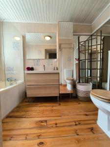 a bathroom with a tub and a toilet and a sink at Splendid T4 - Spacious - Air conditioning - 6 People in Pau