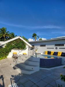 a house with a staircase and a swimming pool at Villa Boscardi in Belize City