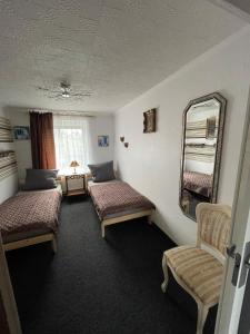 a room with two beds and a mirror at Nussknackerstube in Seiffen