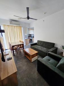 a living room with a couch and a table at Crescent Luxe Stays in Ernakulam