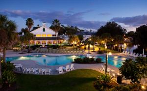a resort with a pool and chairs and a building at Plantation Resort on Crystal River in Crystal River