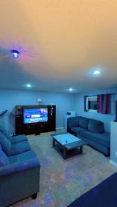 a living room with two couches and a tv at DM Stays in Brandon