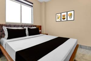 Ένα ή περισσότερα κρεβάτια σε δωμάτιο στο Super Hotel O Netaji Metro Station Kolkata Formerly Mahamaya Step Inn +21 φωτογραφίες