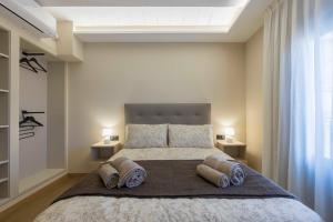 a bedroom with a large bed with two pillows at Portal Fosc Suites in Peniscola
