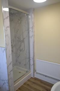 a shower with a glass door in a bathroom at Royal Oak Apartment in Brewood +13 photos
