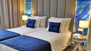 Uma cama ou camas num quarto em Lisbon Sao Bento Hotel