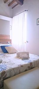 ein Schlafzimmer mit zwei Betten und einem großen Fenster in der Unterkunft Locanda la Rocca Residenza d'Epoca in Fossombrone