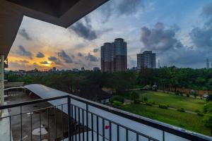 a balcony with a view of a park and buildings at Crescent Luxe Stays in Ernakulam