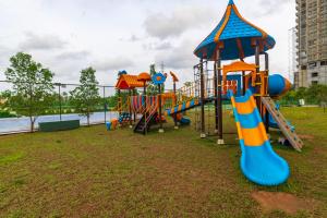 a playground in a park next to the water at Crescent Luxe Stays in Ernakulam
