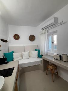 a small room with a bed and a window at Cycladic Home Vorea in Ios Chora