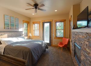 a bedroom with a bed and a flat screen tv at Spring Shores Lodge - Luxury Mountain Experience! in Ashton