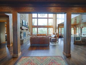a large living room with a couch and a fireplace at Spring Shores Lodge - Luxury Mountain Experience! in Ashton