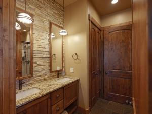 a bathroom with two sinks and a wooden door at Spring Shores Lodge - Luxury Mountain Experience! in Ashton +41 photos