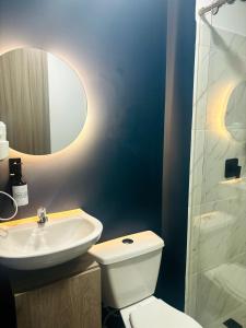 a bathroom with a toilet and a sink and a shower at Moore 45 Tu Espacio Comodo en Medellín in Medellín +180 photos