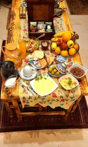 a table full of food and fruit on a table at El-Beit in Siwa