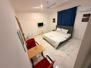 Ένα ή περισσότερα κρεβάτια σε δωμάτιο στο Stadium Haven Hotel