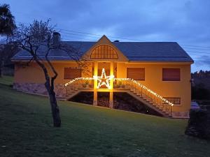 a house with christmas lights on the front of it at Casona La Zampuca in Gijón