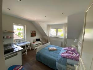 a small bedroom with a bed and a desk at Bed and Breakfast Orange-Inn in Krefeld