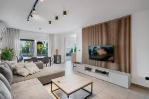 a living room with a couch and a tv at Villa Bardo in Opatija