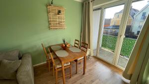 a dining room table and chairs in a living room at Charming accommodation in Radebeul Altkötzenbroda in Radebeul +6 photos