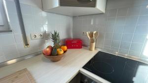 a bowl of fruit on a counter in a kitchen at Charming accommodation in Radebeul Altkötzenbroda in Radebeul