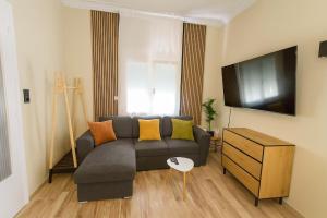 a living room with a couch and a tv at Mi Casa Chios in Chios