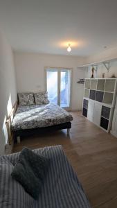 a bedroom with two beds and a large window at Le Plein Sud - Carqueiranne in Carqueiranne