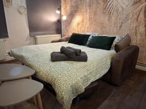 a bed with two towels on top of it at L'elegant hyper centre in Dunkerque