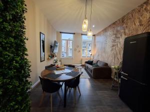 a living room with a table and a couch at L'elegant hyper centre in Dunkerque