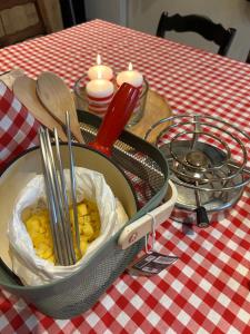 a pan with utensils in it on a table at Histoire d Ardenne in La Roche-en-Ardenne