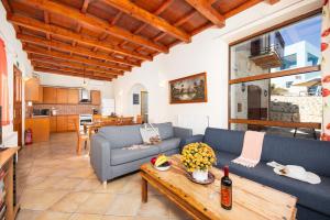 a living room with a couch and a table at Villa Top Hill in Agia Triada